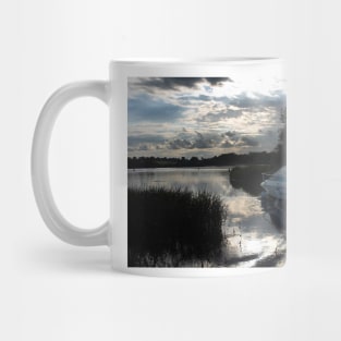 A boat travelling the Norfolk Broads near dusk Mug